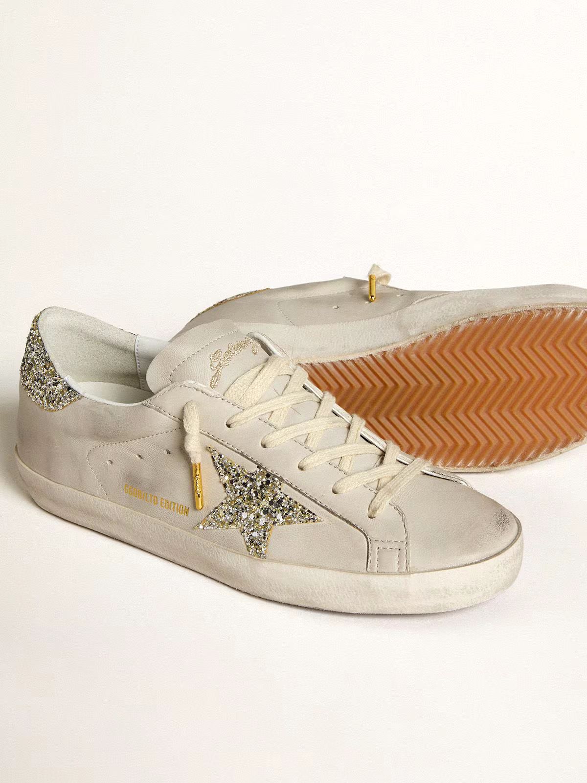 Super-Star LTD aus elfenbeinfarbenem Nappa mit Stern und Fersenpartie aus platinfarbenem Glitzer